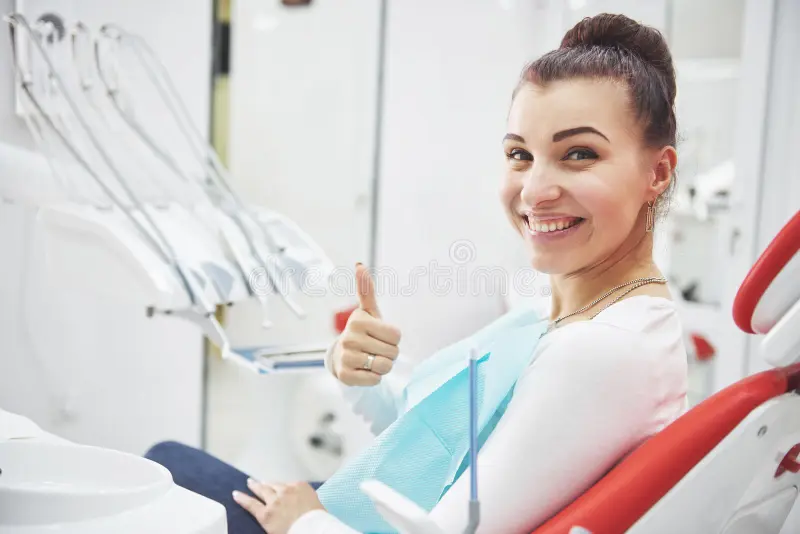 Satisfied patient with perfect smile after dental treatment